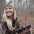 Campfire Collective Hunting Ambassador Ashley Dill holding a bolt-action rifle while hunting for whitetail deer.