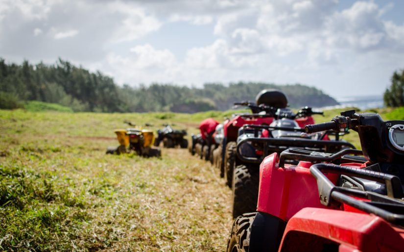Line of ATVs parked along a trail in Northwest Ontario.