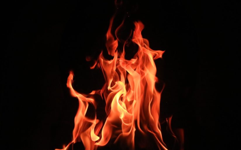 Close-up shot of orange flames from a campfire.