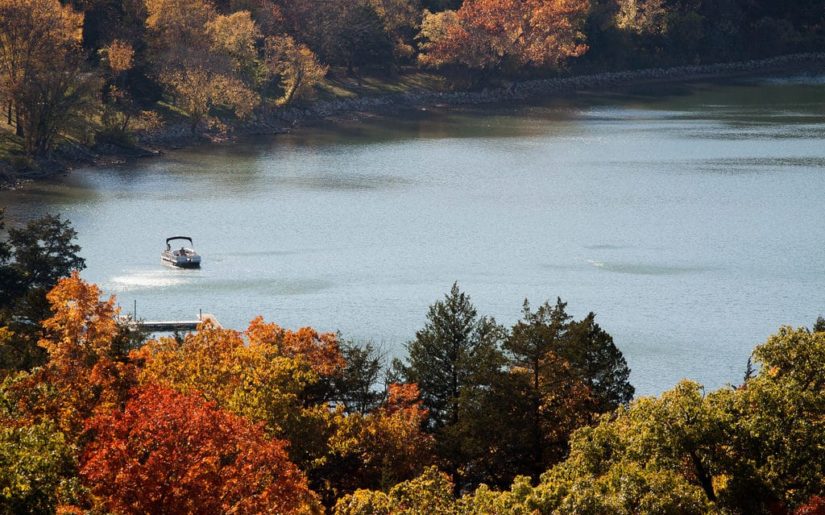 Pontoon boat on a Missouri lake in fall.