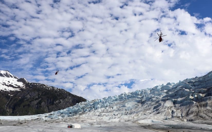 Helicopters flying over Mendenhall Glacier, Alasksa.