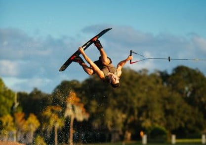Campfire Collective Ambassador Billy Allen performing trick on his wakeboard.